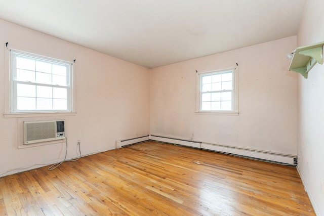 2609 Parkview Pl, Baldwin, NY 11510 - unfurnished room with a wall unit AC, light wood-style flooring, and a baseboard heating unit