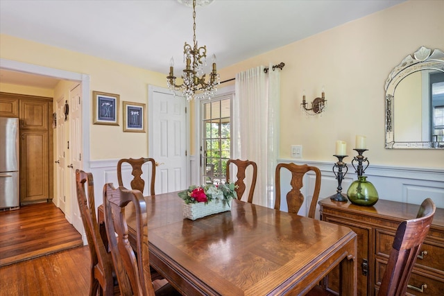 2564 Central Ave Unit B, Baldwin, NY 11510 - dining room with a chandelier, wainscoting, dark wood-type flooring, and a decorative wall