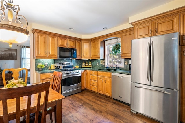 2564 Central Ave Unit B, Baldwin, NY 11510 - kitchen with stainless steel appliances, backsplash, dark wood finished floors, dark countertops, and brown cabinets