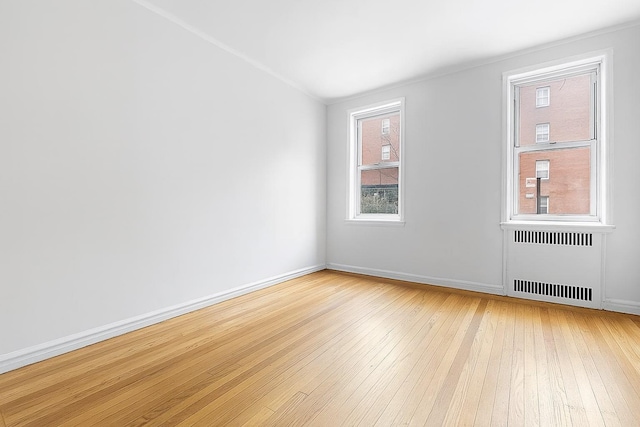63109 Saunders St Unit 3A, Rego Park, NY 11374 - spare room featuring radiator and light wood-style flooring