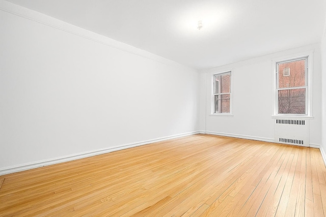 63109 Saunders St Unit 3A, Rego Park, NY 11374 - spare room with radiator and light wood-type flooring