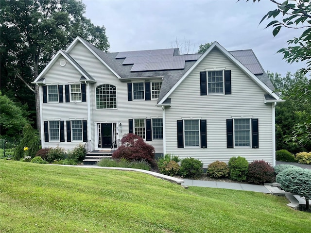 20 Long View Dr, Unionville, NY 10988 - view of front of house featuring a front yard, roof mounted solar panels, and a shingled roof