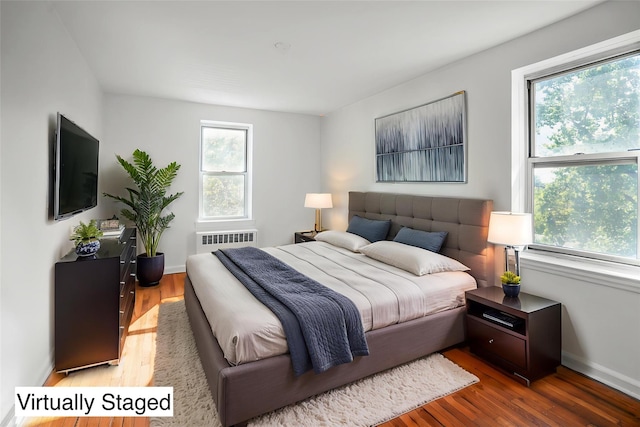 63-61 Yellowstone Blvd Unit 3E, Forest Hills, NY 11375 - bedroom featuring wood finished floors and radiator heating unit