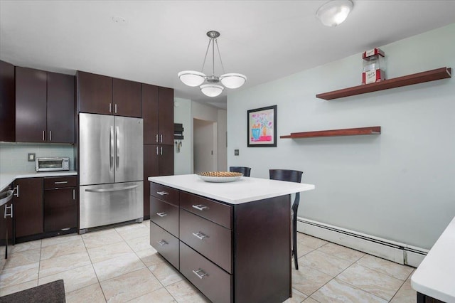 32 Brady Ave, New Rochelle, NY 10805 - kitchen featuring freestanding refrigerator, a baseboard heating unit, light countertops, and dark brown cabinetry