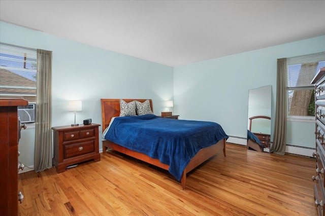32 Brady Ave, New Rochelle, NY 10805 - bedroom featuring light wood-style floors, baseboard heating, and cooling unit