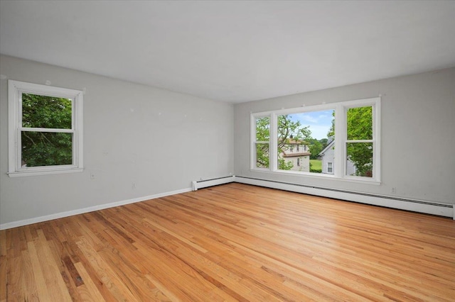 32 Brady Ave, New Rochelle, NY 10805 - empty room featuring plenty of natural light, light wood-style flooring, and a baseboard radiator