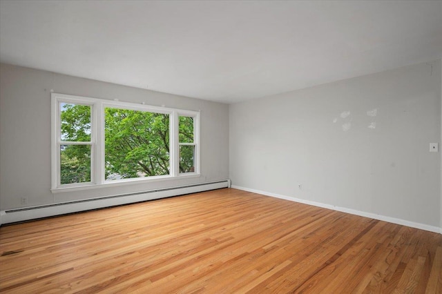 32 Brady Ave, New Rochelle, NY 10805 - empty room with a baseboard heating unit and wood finished floors