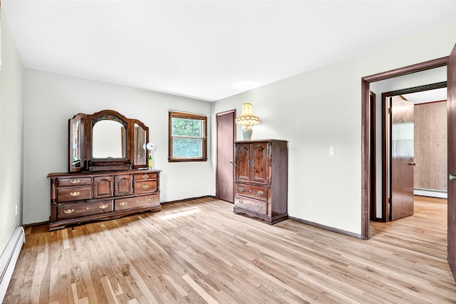 408 Bull Rd, Rock Tavern, NY 12575 - unfurnished bedroom featuring a baseboard heating unit and light wood finished floors