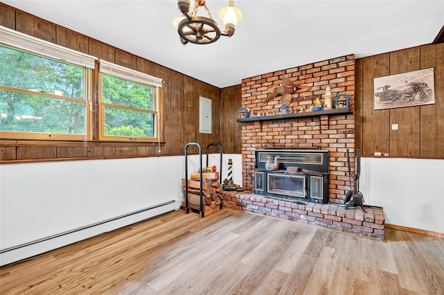 408 Bull Rd, Rock Tavern, NY 12575 - living area featuring a baseboard heating unit, wood finished floors, a chandelier, wooden walls, and a brick fireplace