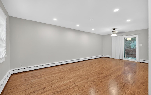1152 N Country Rd, Stony Brook, NY 11790 - spare room featuring a baseboard radiator, wood finished floors, recessed lighting, and ceiling fan
