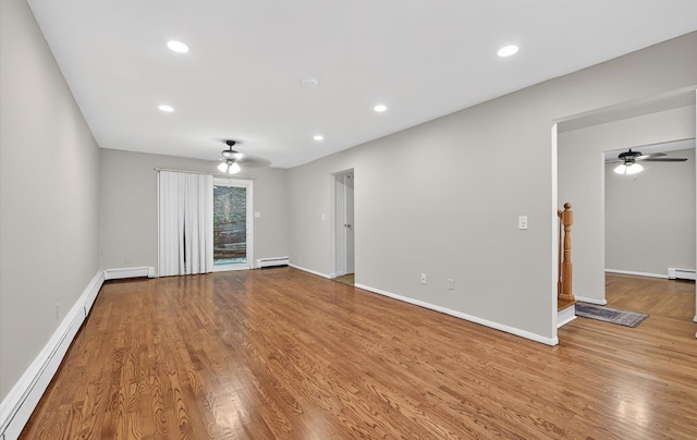 1152 N Country Rd, Stony Brook, NY 11790 - empty room featuring a baseboard heating unit, ceiling fan, wood finished floors, and recessed lighting