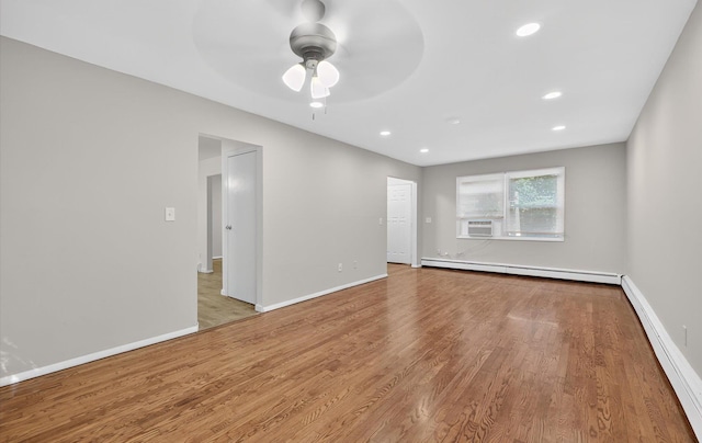 1152 N Country Rd, Stony Brook, NY 11790 - spare room with baseboard heating, ceiling fan, wood finished floors, and recessed lighting