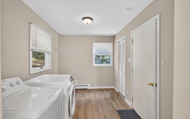 1152 N Country Rd, Stony Brook, NY 11790 - laundry room featuring baseboard heating, washing machine and dryer, and light wood-style floors