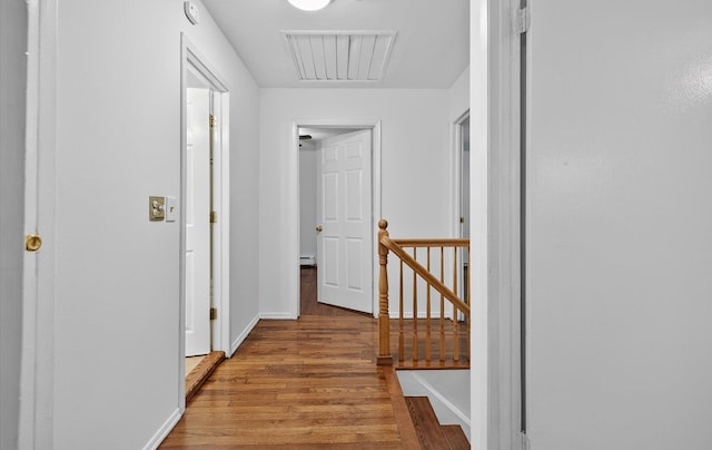1152 N Country Rd, Stony Brook, NY 11790 - corridor with an upstairs landing, wood finished floors, and a baseboard heating unit