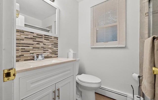 1152 N Country Rd, Stony Brook, NY 11790 - bathroom featuring baseboard heating, tasteful backsplash, vanity, and tiled shower