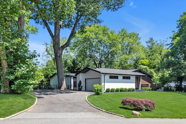 3 Horseshoe Ln, Great Neck, NY 11020 - view of front of home featuring driveway, a garage, and stucco siding