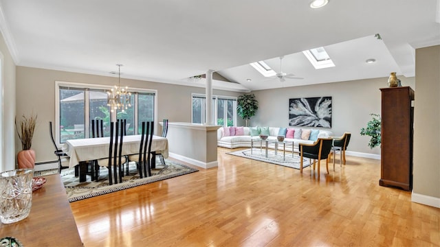12 Hasting Dr, Stony Brook, NY 11790 - dining room featuring light wood finished floors, lofted ceiling, a chandelier, a skylight, and a baseboard heating unit