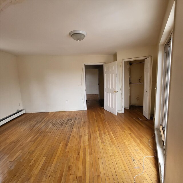 1754 Givan Ave, Bronx, NY 10469 - empty room featuring light wood finished floors and baseboard heating