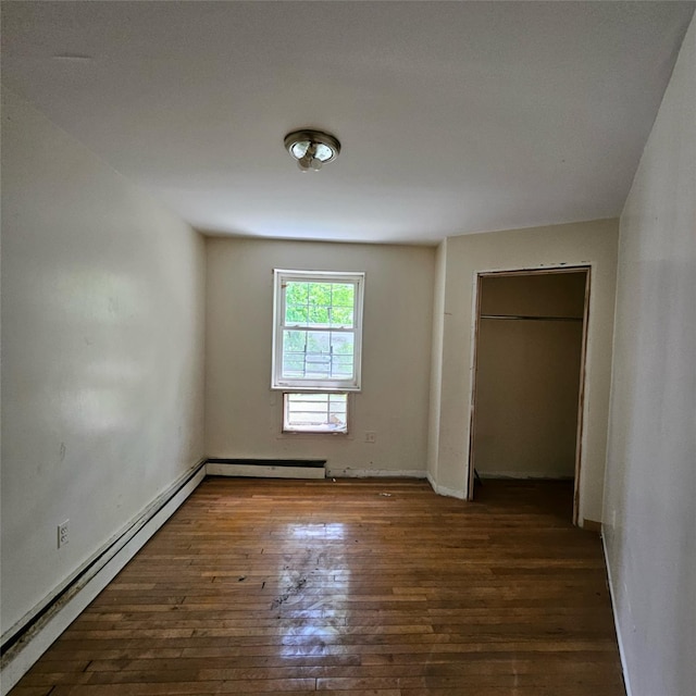 1754 Givan Ave, Bronx, NY 10469 - unfurnished bedroom featuring wood-type flooring and a baseboard heating unit