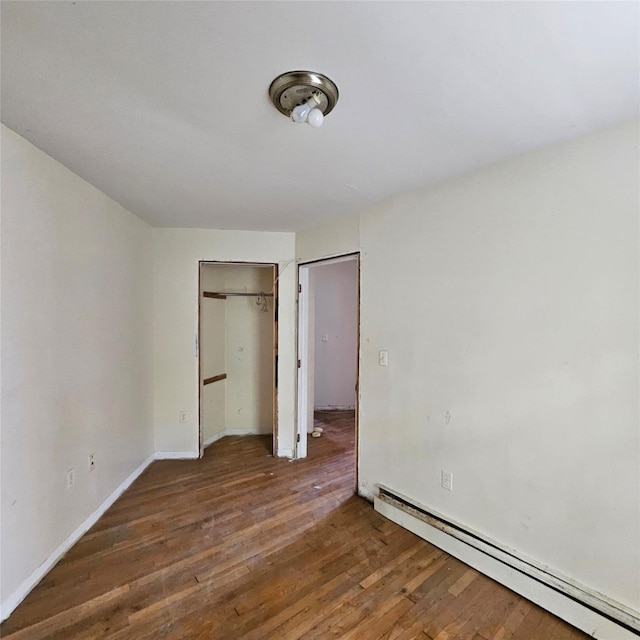 1754 Givan Ave, Bronx, NY 10469 - unfurnished bedroom with baseboard heating, hardwood / wood-style flooring, and a closet