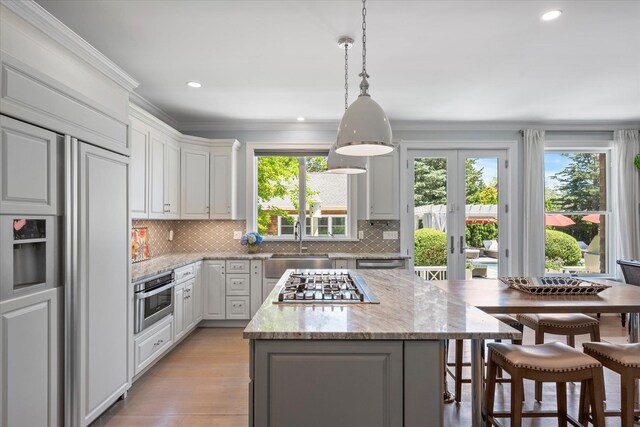 12 Terry Dr, Shelter Island, NY 11964 - kitchen with appliances with stainless steel finishes, ornamental molding, decorative backsplash, recessed lighting, and french doors