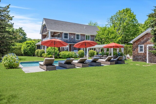 12 Terry Dr, Shelter Island, NY 11964 - rear view of house featuring an outdoor hangout area, a yard, a patio, an outdoor pool, and roof with shingles