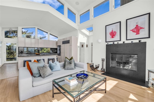 146 Ocean Walk, Fire Island Pines, NY 11782 - living area featuring a towering ceiling, light wood finished floors, and healthy amount of natural light