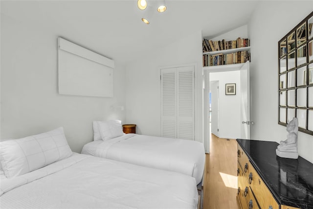 146 Ocean Walk, Fire Island Pines, NY 11782 - bedroom featuring a closet, light wood finished floors, and lofted ceiling