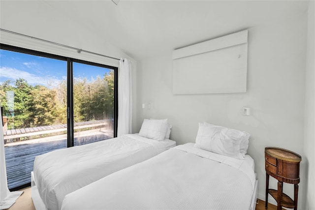 146 Ocean Walk, Fire Island Pines, NY 11782 - bedroom featuring lofted ceiling and access to exterior