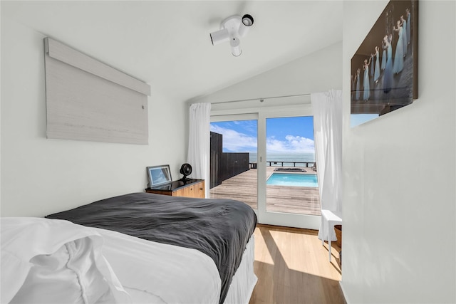 146 Ocean Walk, Fire Island Pines, NY 11782 - bedroom featuring access to outside, lofted ceiling, and wood finished floors