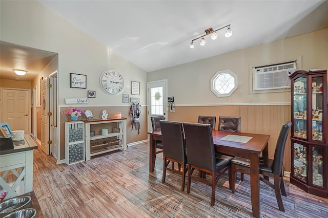 8 Glenwood Pl, Farmingville, NY 11738 - dining space with a wainscoted wall, an AC wall unit, wood finished floors, and wood walls