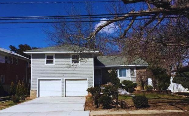 view of front of house with a garage and concrete driveway