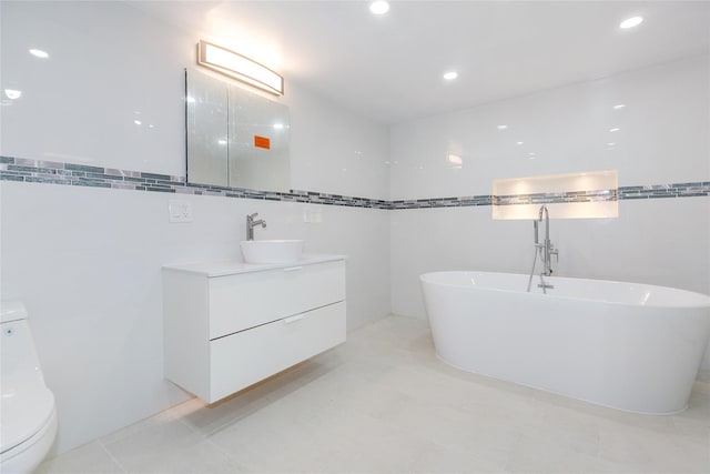 5 Bellingham Ln, Great Neck, NY 11023 - full bath with tile walls, vanity, a freestanding bath, and recessed lighting