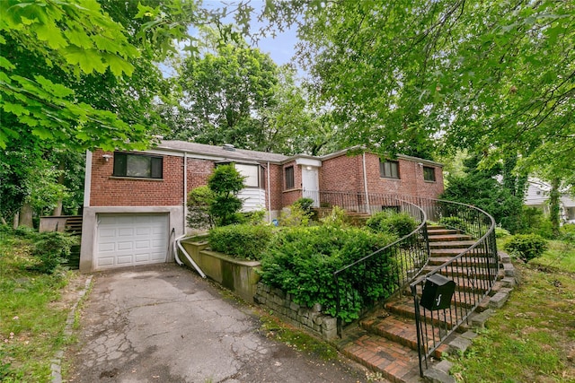 5 Bellingham Ln, Great Neck, NY 11023 - single story home featuring stairway, brick siding, an attached garage, and asphalt driveway