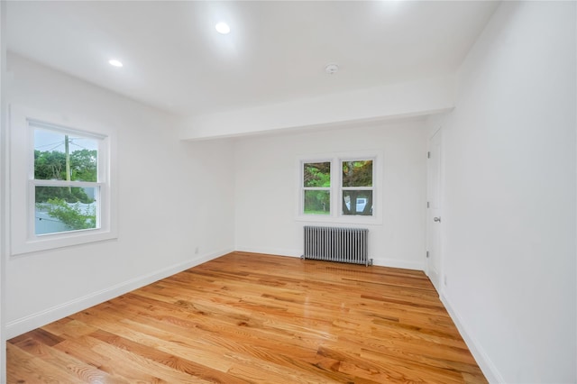 17 Pinetree Dr, Shirley, NY 11967 - empty room with radiator, light wood-type flooring, and recessed lighting