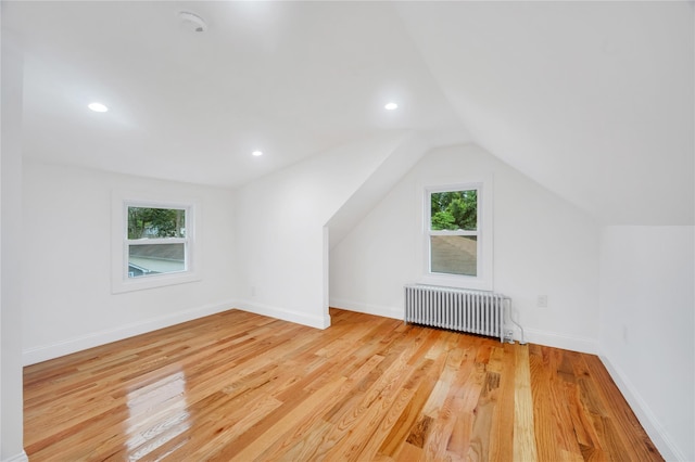 17 Pinetree Dr, Shirley, NY 11967 - additional living space with radiator heating unit, wood finished floors, lofted ceiling, and recessed lighting