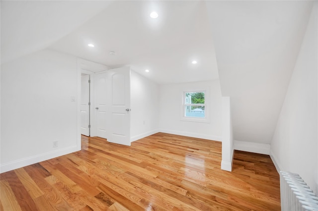 17 Pinetree Dr, Shirley, NY 11967 - bonus room with radiator, vaulted ceiling, light wood-style flooring, and recessed lighting