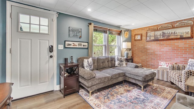27 Lidge Dr, Farmingville, NY 11738 - living room featuring light wood-style flooring, brick wall, recessed lighting, and an accent wall