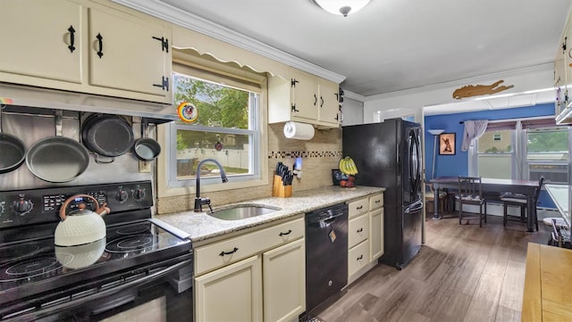 27 Lidge Dr, Farmingville, NY 11738 - kitchen with black appliances, decorative backsplash, ornamental molding, wood finished floors, and plenty of natural light