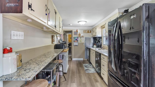27 Lidge Dr, Farmingville, NY 11738 - kitchen featuring black appliances, light wood-type flooring, crown molding, and light stone countertops