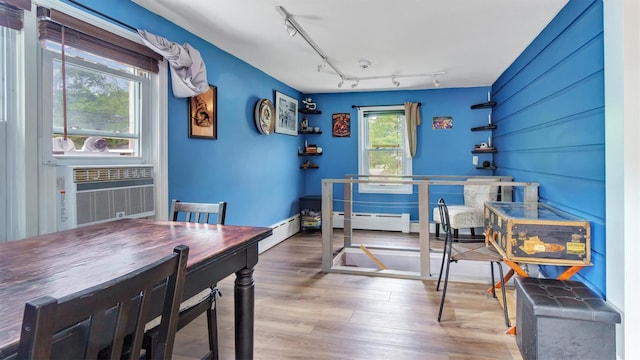 27 Lidge Dr, Farmingville, NY 11738 - dining room with wood finished floors, rail lighting, and a baseboard heating unit