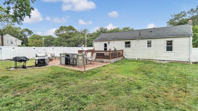 27 Lidge Dr, Farmingville, NY 11738 - back of property featuring a fenced backyard, a deck, a patio, a shingled roof, and a chimney