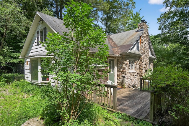 1973 State Route 17k, Montgomery, NY 12549 - view of side of property with a deck, roof with shingles, a chimney, and stone siding