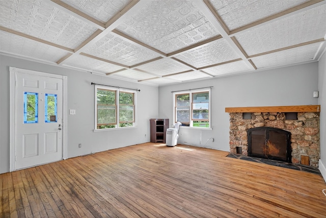 1973 State Route 17k, Montgomery, NY 12549 - unfurnished living room featuring wood-type flooring, a stone fireplace, coffered ceiling, and an ornate ceiling