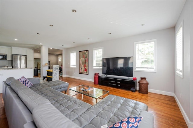 1136 W Broadway, Hewlett, NY 11557 - living room featuring light wood finished floors, healthy amount of natural light, and recessed lighting