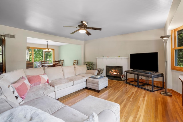 918 Sylvan Ln, Mamaroneck, NY 10543 - living room featuring light wood-type flooring, ceiling fan, and a fireplace