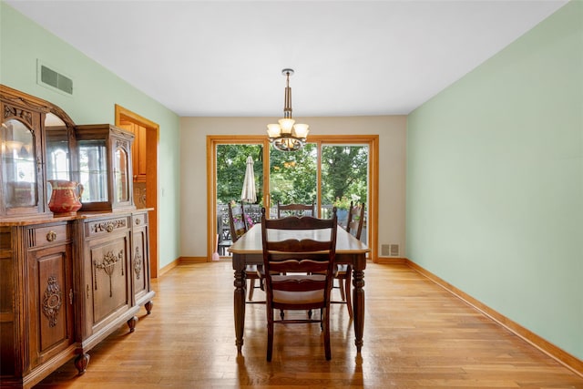 918 Sylvan Ln, Mamaroneck, NY 10543 - dining space with a chandelier and light wood-style flooring