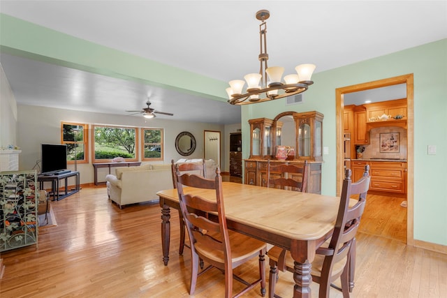918 Sylvan Ln, Mamaroneck, NY 10543 - dining space with light wood-style flooring, a chandelier, and ceiling fan