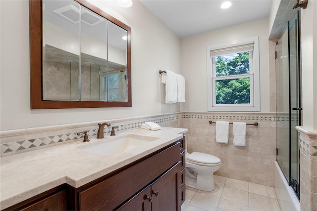 918 Sylvan Ln, Mamaroneck, NY 10543 - full bath featuring tile walls, tile patterned floors, vanity, a wainscoted wall, and enclosed tub / shower combo