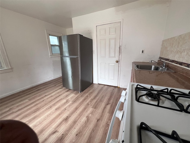11617 141st St, Jamaica, NY 11436 - kitchen featuring freestanding refrigerator, white range with gas stovetop, and light wood-type flooring